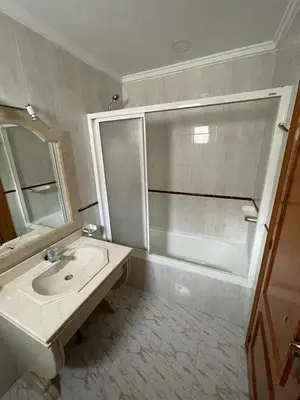 a bathroom with a sink and a shower and a mirror at Precioso adosado con parking a 100 metros de la playa in Playa de Mar