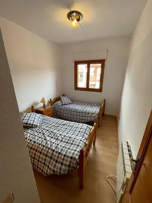 a room with two beds and a window at Precioso adosado con parking a 100 metros de la playa in Playa de Mar