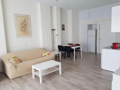 a living room with a couch and a table at Studio Sorolla - Spacious studio near Valencia's beaches in Valencia