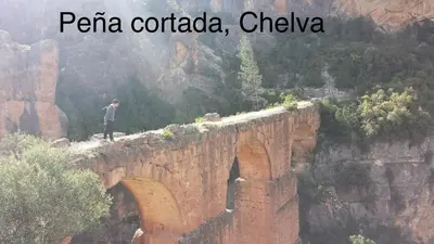 a man standing on top of a stone bridge at Apartamentos Casa Anselmo EL TERRAO in Losa del Obispo