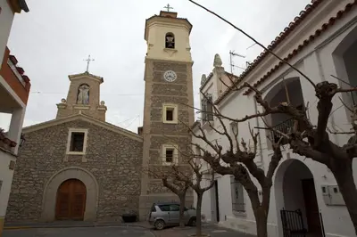 a church with a clock tower on a building at Casa Arminda in Benafer