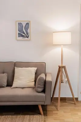 a living room with a couch and a lamp at Apartamentos FV Flats Valencia - Mestalla 7 in Valencia