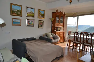 a living room with a bed and a table and chairs at Casa el Castell in Eslida