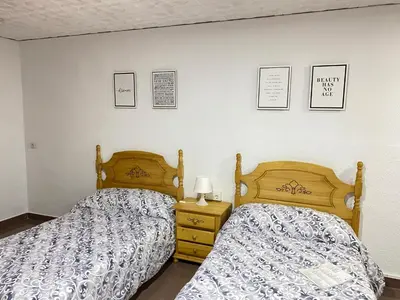 two beds sitting next to each other in a bedroom at Casa Mayor in Tous