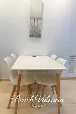 a white dining table with white chairs in a room at BEACH VALENCIA LUXURY A40-13 Apartment with terrace and sea views in Valencia