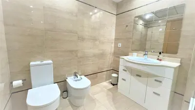 a bathroom with a toilet and a sink and a mirror at BEACH VALENCIA LUXURY A40-13 Apartment with terrace and sea views in Valencia