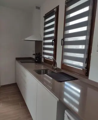 a kitchen counter with a sink and a window at Apartamentos LOSA RURAL in Losa del Obispo