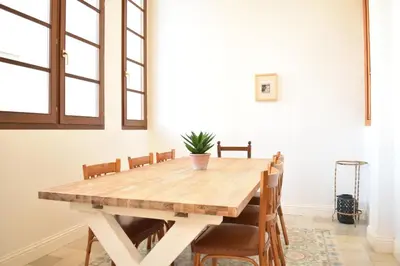 a dining room with a wooden table and chairs at Gran apartamento cerca de Ruzafa in Valencia