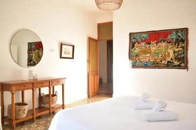 a bedroom with a bed and a mirror and a table at Gran apartamento cerca de Ruzafa in Valencia