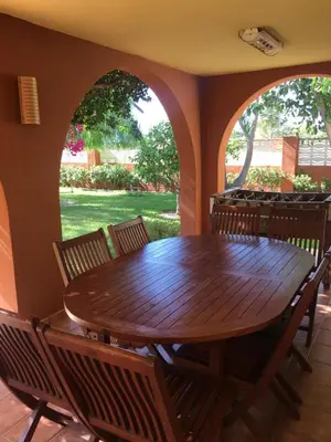a dining room with a wooden table and chairs at Casa buganvilla in Almarda