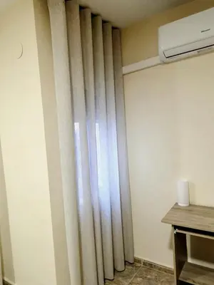 a curtain in the corner of a room at Entire Apartment near Valencia - 2 Bedrooms & 2 Bathrooms in Paterna