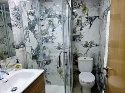 a bathroom with a shower and a toilet and a sink at Entire Apartment near Valencia - 2 Bedrooms & 2 Bathrooms in Paterna