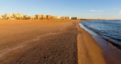 a view of the beach with buildings in the background at Puerto Playa Paradise in Puerto de Sagunto