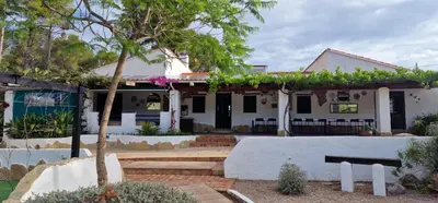 a white house with a patio and a tree at Casa Azahara your Valencian Villa in Macastre