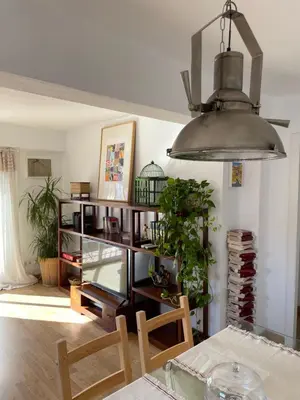 a living room with a table and a chandelier at La casita de Jimena in Valencia