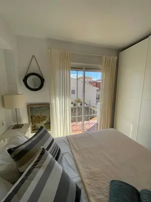 a bedroom with a bed and a window with a view at La casita de Jimena in Valencia