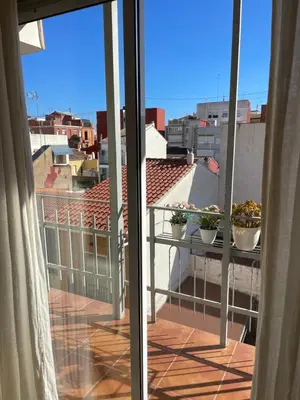 a balcony with two potted plants on a roof at La casita de Jimena in Valencia