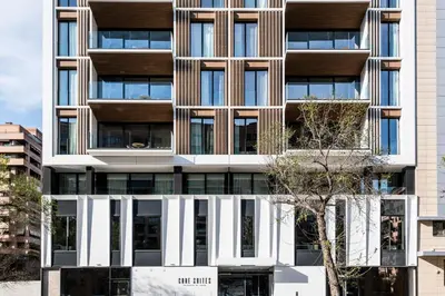 an apartment building with a facade with windows at Apartamentos Core Suites Valencia in Valencia