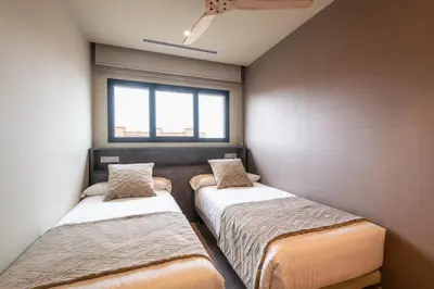 two beds in a small room with a window at Apartamentos Core Suites Valencia in Valencia