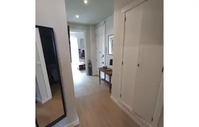 a hallway with white walls and a mirror at Classic City Apartment in Valencia