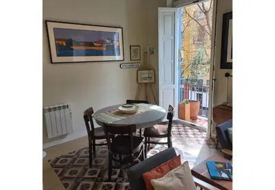 a dining room with a table and chairs and a window at Classic City Apartment in Valencia