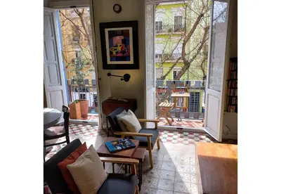 a living room with two chairs and a large window at Classic City Apartment in Valencia