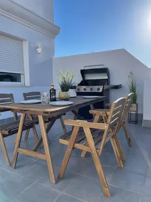 a picnic table with two chairs and a grill at UIM Mediterraneo ATICO Felipe Wifi in Puerto de Sagunto