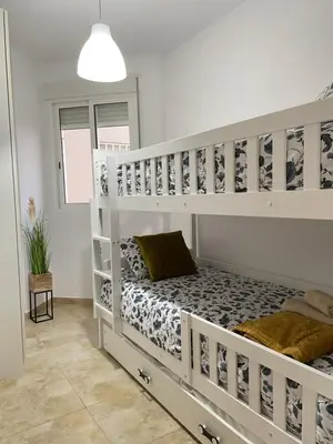 a bedroom with two bunk beds in a room at UIM Mediterraneo ATICO Felipe Wifi in Puerto de Sagunto
