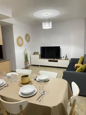a living room with a table and a couch at UIM Mediterraneo ATICO Felipe Wifi in Puerto de Sagunto