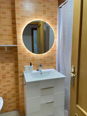a bathroom with a sink and a mirror at UIM Mediterraneo ATICO Felipe Wifi in Puerto de Sagunto