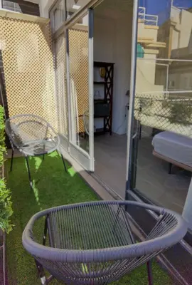 a patio with a bench and a balcony with a balcony at City Hall Central Market in Valencia