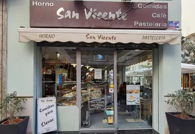 a store front of a bakery with a sign on it at City Hall Central Market in Valencia
