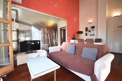 a living room with a couch and a tv at Bello Apartamento en la Plaza del Tossal in Valencia