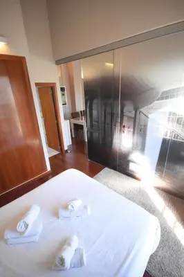 a bedroom with a bed with two towels on it at Bello Apartamento en la Plaza del Tossal in Valencia