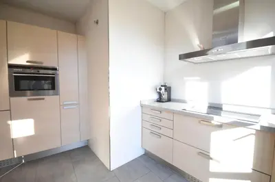 a kitchen with white cabinets and a stove at Bello Apartamento en la Plaza del Tossal in Valencia