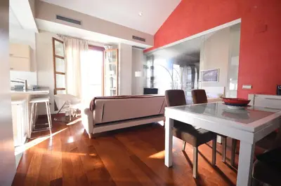 a living room with a table and a couch at Bello Apartamento en la Plaza del Tossal in Valencia