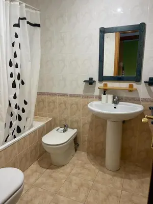 a bathroom with a sink and a toilet and a mirror at UIM Mediterraneo Diagonal 16 Wfi in Puerto de Sagunto