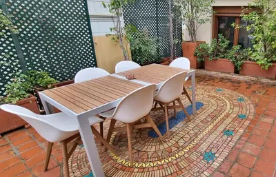 a wooden table and chairs on a patio at Valencia Green Penthouse in Valencia