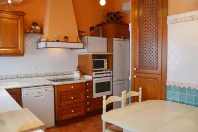 a kitchen with a table and a stove top oven at Valencia Green Penthouse in Valencia