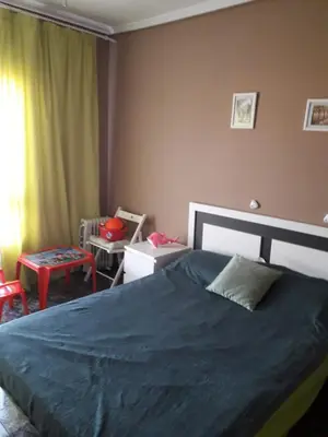 a bedroom with a large bed with a blue blanket at Amplio piso en Sagunto in Sagunto