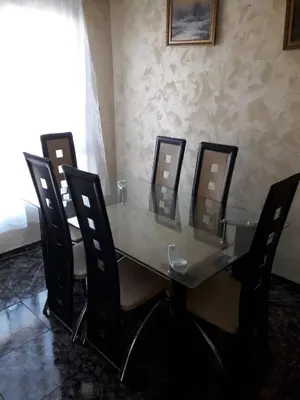 a dining room table and chairs with a glass table and eight chairs at Amplio piso en Sagunto in Sagunto
