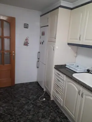 a kitchen with white cabinets and a sink at Amplio piso en Sagunto in Sagunto