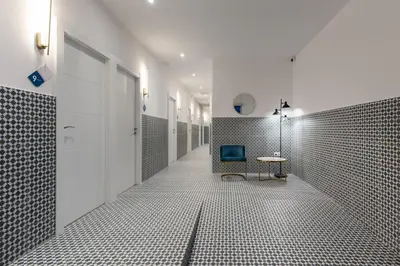 a bathroom with a walk in shower and a table at Hotelito Boutique Valencia Estación in Valencia