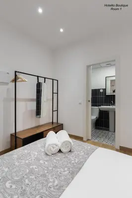 a bedroom with a bed with two towels on it at Hotelito Boutique Valencia Estación in Valencia