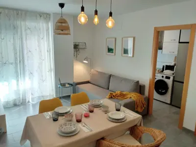a living room with a table and a couch at Apartamento acogedor en playa de Moncofa in Moncófar