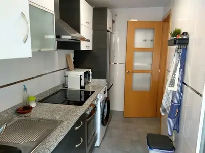 a small kitchen with a sink and a stove at Apartamento acogedor en playa de Moncofa in Moncófar