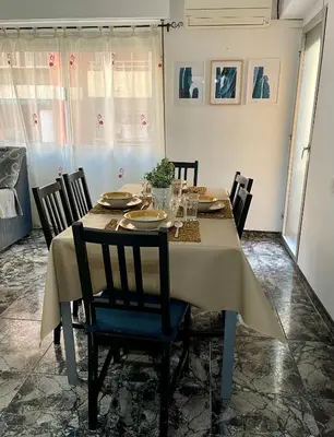 a dining room with a table and chairs at UIM Mediterraneo Juana Wifi in Puerto de Sagunto