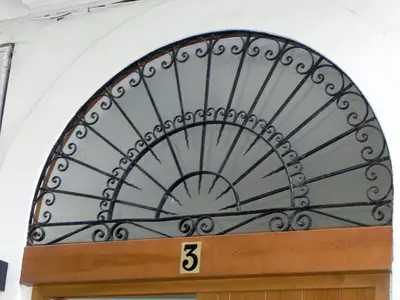 a metal object over a door with the number five at Catalina Suites Apartments Downtown Valencia in Valencia