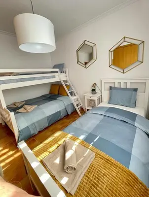 a bedroom with two bunk beds and a mirror at UIM Mediterraneo PB Plomo 2 Wifi in Puerto de Sagunto