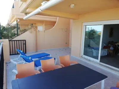 a dining room with a blue table and chairs at Oasis Solo Familias Serviplaya in Casas Las Basas